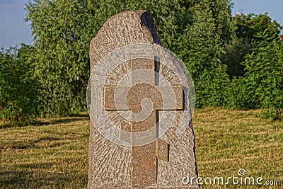 One brown granite monument with a cross stands on a grave Editorial Stock Photo