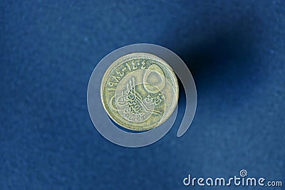 brown old egypt coin lies on a gray background Stock Photo