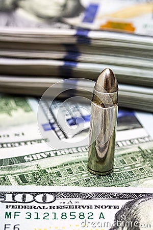 One bullet on american dollars background Stock Photo