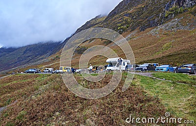 One of the Car Parks and Viewing points along the A82 road in Glencoe, with Visitors Vehicles parked. Editorial Stock Photo