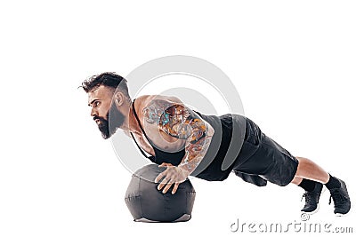 One caucasian man exercising fitness weights Medicine Ball push ups exercises in studio isolated on white background Stock Photo