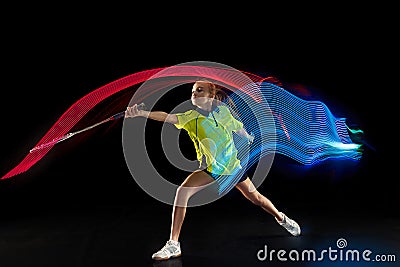 One caucasian young teenager girl woman playing Badminton player on black background Stock Photo