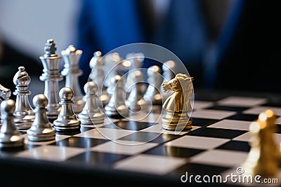 One chess piece against many on chessboard Stock Photo