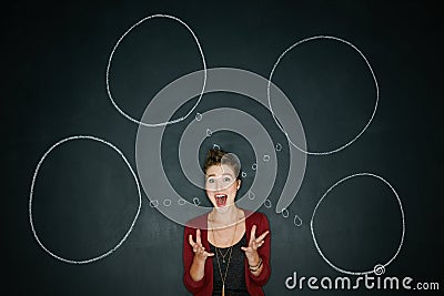 One crazy idea leads to another. Studio shot of a young woman posing with a chalk illustration of thought bubbles Cartoon Illustration