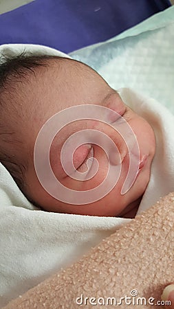 One day old Baby Girl with delicate skin and head covered Stock Photo