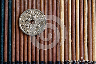 Denmark coin denomination is 1 krone (crown) lie on wooden bamboo table, good for background or postcard Stock Photo