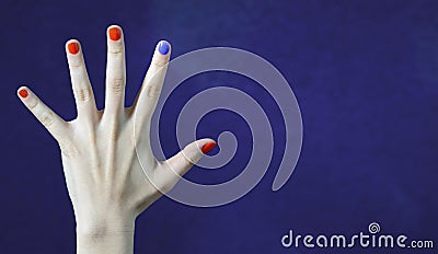 One different nail color in finger in caucasian hand. Red and blue painted fingernails. Stock Photo