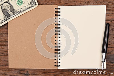 One dollar bill and pen with notebook for background. Stock Photo