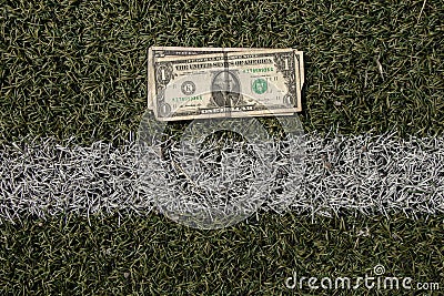 one dollar lies on a green lawn, a carriage of a white stripe, money for the road Stock Photo
