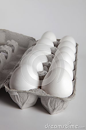 One Dozen White Eggs Inside an Egg Carton Stock Photo