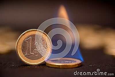 One euro coins on fire Stock Photo