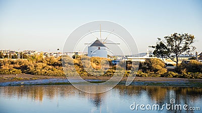 Wind Mill near River Stock Photo