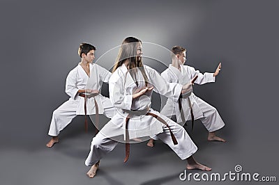 One female and two male brown belt karate doing kata Stock Photo