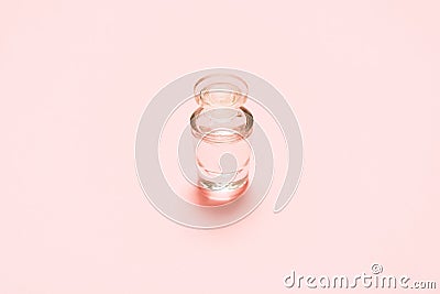 One fragrance bottle with liquid on pink background. Mock-up Stock Photo