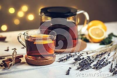 One full Cup of black tea with lemon and teapot Stock Photo