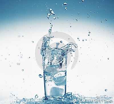 One glass of water with splash from falling ice cube, white background, isolated object Stock Photo