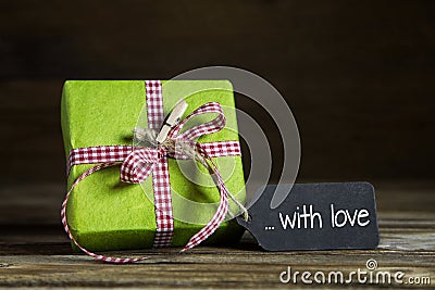 One green present with red white checked ribbon for christmas or Stock Photo