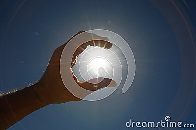 One Hand Catching the Sun Stars on Stock Photo