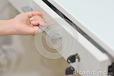 One hand opening white drawer Stock Photo
