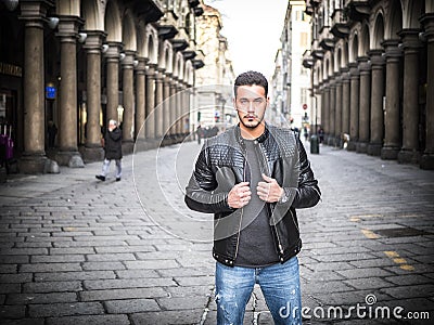 One handsome young man in old classic city setting Stock Photo