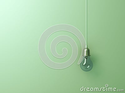 One hanging turn off incandescent light bulb on green wall background Stock Photo