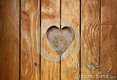 One heart shape carved in vintage wood close up Stock Photo