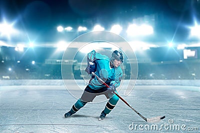 One hockey player skating with stick on ice arena Stock Photo