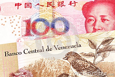 A bolivar note from Venezuela with a yuan note from the People`s Republic of China Stock Photo