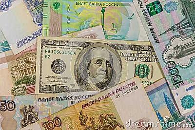 One hundred dollar bill on background of russian rubles banknotes Stock Photo