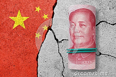 One hundred yuan notes on a cracked concrete background. China finance, real estate and debt crisis. Stock Photo