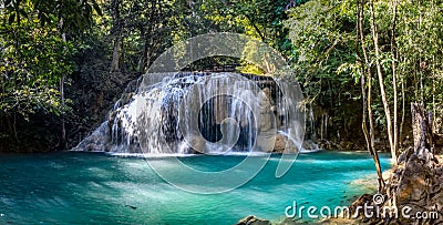 One of the largest waterfalls in Erawan National park in Thailand has a aqua pool with some fish Stock Photo