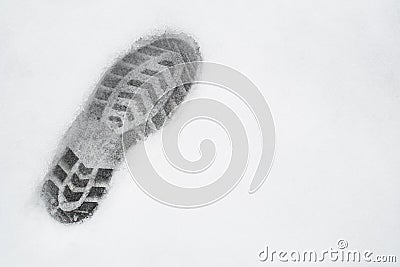 One left foot shoe print on snow, top view, copy space, cloudy Stock Photo