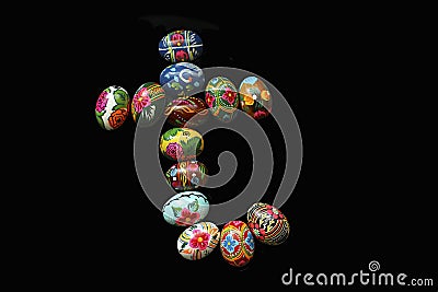 One of the letters of the word `Easter`. Letters are made of Easter eggs, of different colors and with different patterns. On a bl Stock Photo