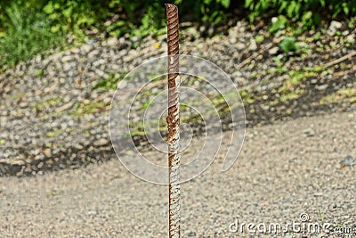 One long rusty iron rod brown rebar Stock Photo