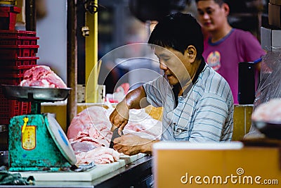 One man cutting chicken meat Editorial Stock Photo