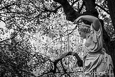 One of the many sculptures in the gardens of Schloss SchÃ¶nbrunn in Vienna, Austria. Stock Photo