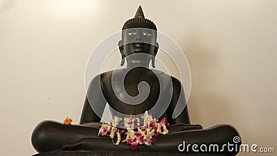 One Metal Buddha With FlowersGarland Stock Photo