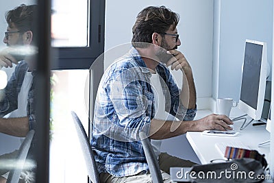 One modern worker using computer and looking screen with doubts. Office job and problems. People using technology and internet Stock Photo