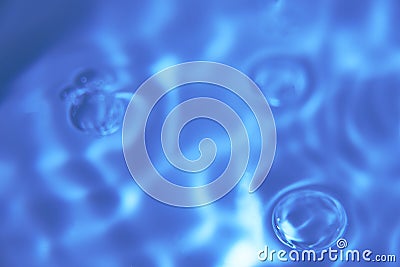 079.One or more drops of water splashing into waves and undefined shapes. Wallpaper Stock Photo