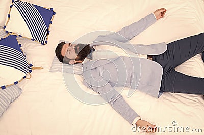 One more long day ended. Feel tired and sleepy. Sleepy guy in formal clothes sleep on bed. Lack of sleep. Need more Stock Photo