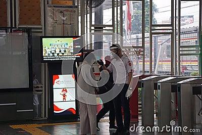 Checking body temperature to the passenger entering the station Editorial Stock Photo