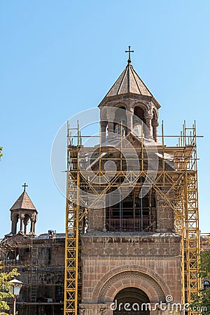 Armenia, Echmiadzin, September 2021. Yellow scaffolding around the bell tower of the old cathedral. Editorial Stock Photo