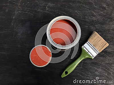 One open can with beautiful red paint on a black matte wooden background. Stock Photo