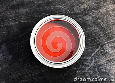 One open can with beautiful red paint stands on a black matte wooden background. Stock Photo