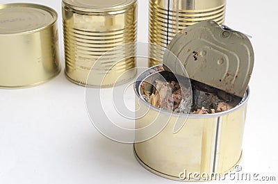 One open fish can on a background of cans of canned food on a white background.Copyspace. Stock Photo