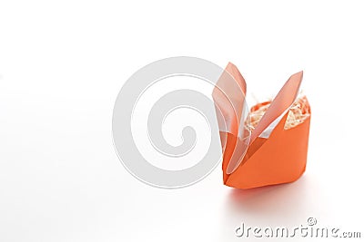 One Orange Origami Easter Bunny Basket Stuffed with Straw Stock Photo