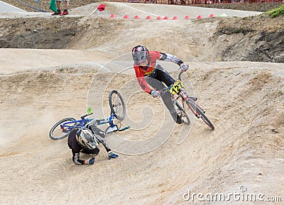 One of the pair of young racers on the bike is falling Editorial Stock Photo