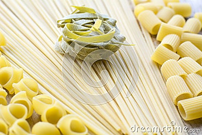 One piece of green raw pasta is on the linguini Stock Photo