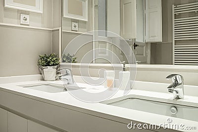 One-piece washbasin with two sinks and two taps in a bathroom Stock Photo