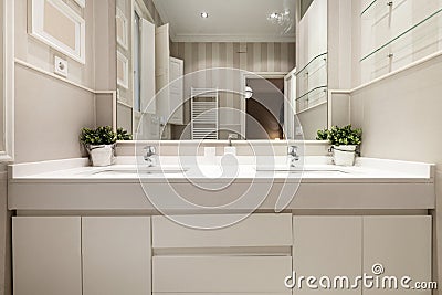 One-piece washbasin with two sinks and two taps in the bathroom Stock Photo